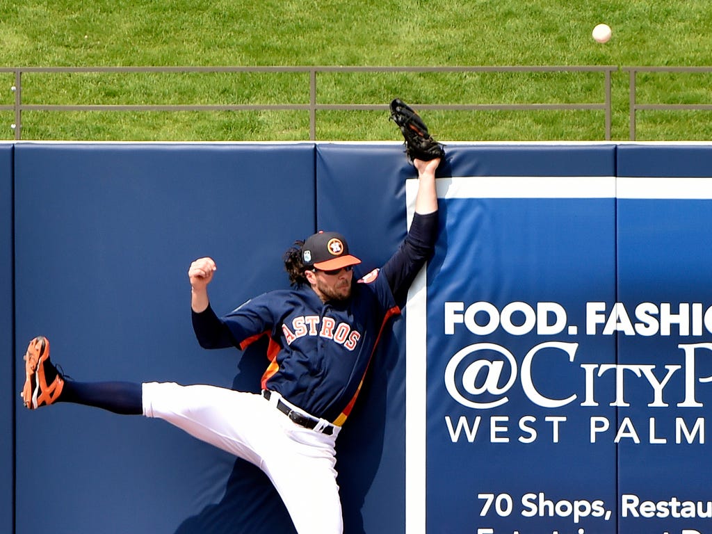 Houston Astros center fielder Jake Marisnick is unable to make a catch that was ruled a home run from Washington Nationals third baseman Anthony Rendon during a spring training game at The Ballpark of the Palm Beaches.