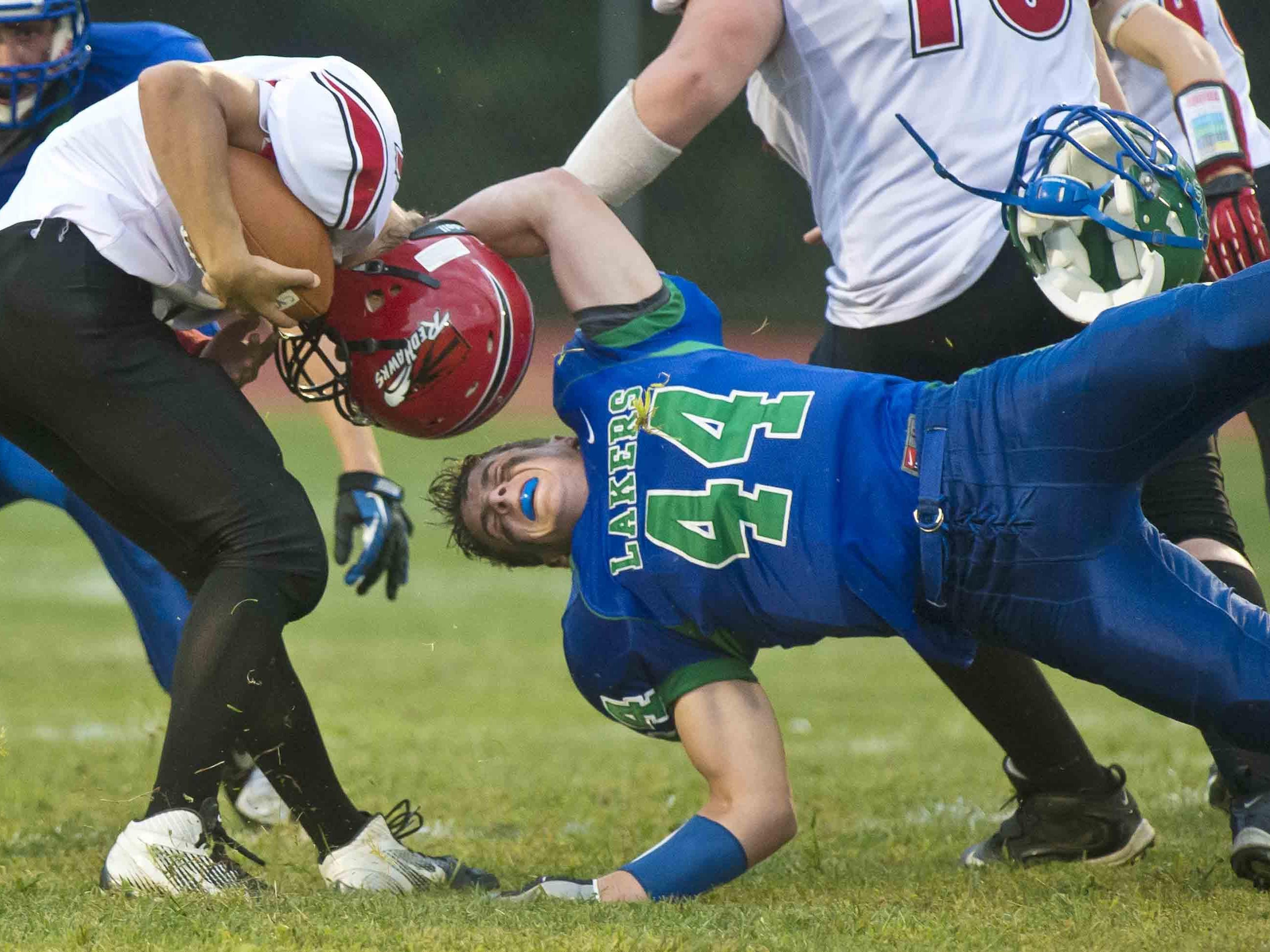 Colchester’s Grant Cummings (right) loses his helmet as he tries to tackle Champlain Valley Union's Andrew Bortnick in a 2013 high school football game.