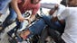 Morsi supporters help a wounded protester as he is evacuated on a motorcycle at Ramses Square.