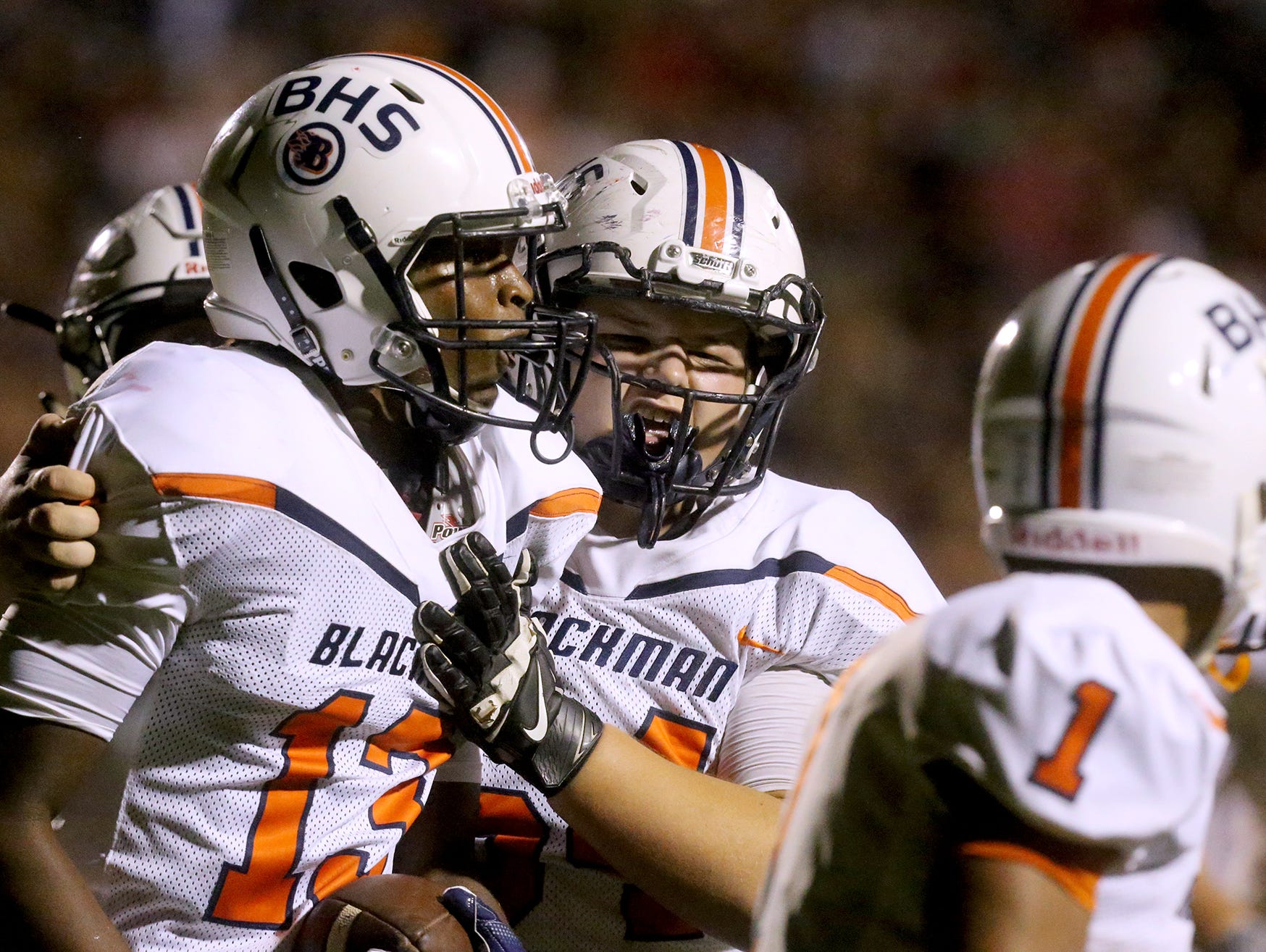 Blackman's Trey Knox (13) and Lance Pawlowski (64) celebrate Knox's touchdown against Riverdale, on Friday, Sept. 2, 2016.