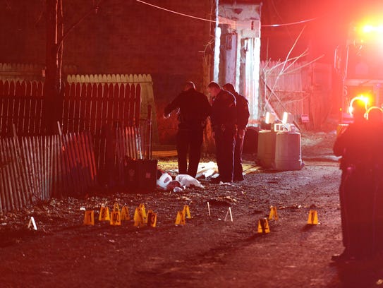 Police investigate the scene after a deadly shooting
