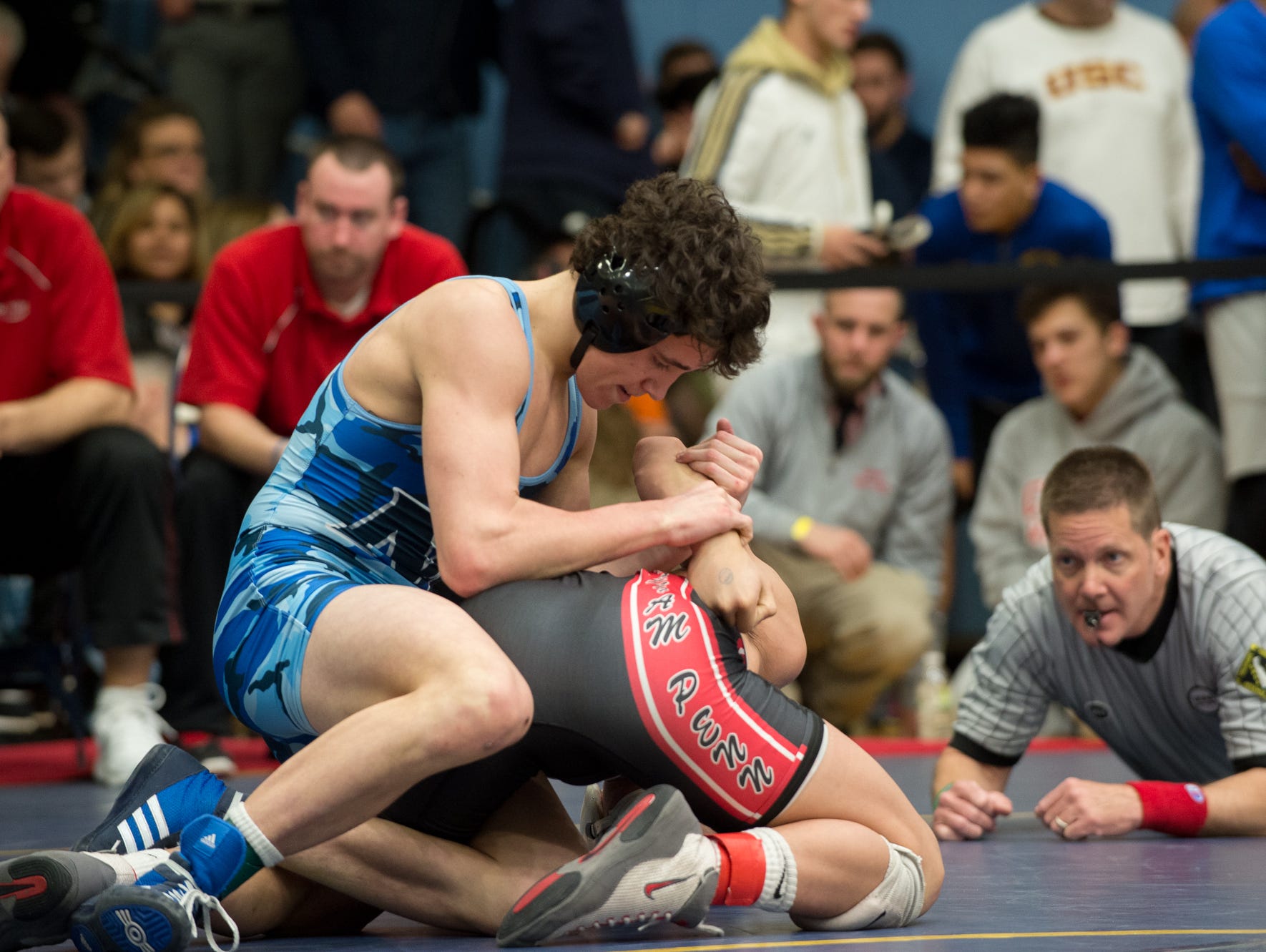 Middletown's Dante Immediate, left wrestles William Penn's Thien Nguyen in the 126 pound quarterfinals at the DIAA Individual State Tournament at Cape Henlopen High School.