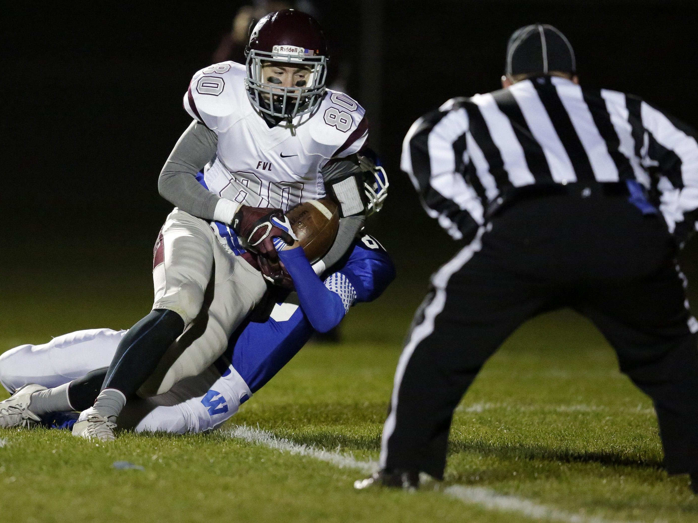 Benjamin Gucinski of Fox Valley Lutheran scores while being tackled by Austin DeCleene of Wrightstown on Friday.