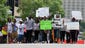 Protesters march outside the Buzz Westfall Justice Center in Clayton, Mo., where a grand jury is expected to convene to consider possible charges against the Ferguson, Mo. police officer who fatally shot 18-year-old Michael Brown.