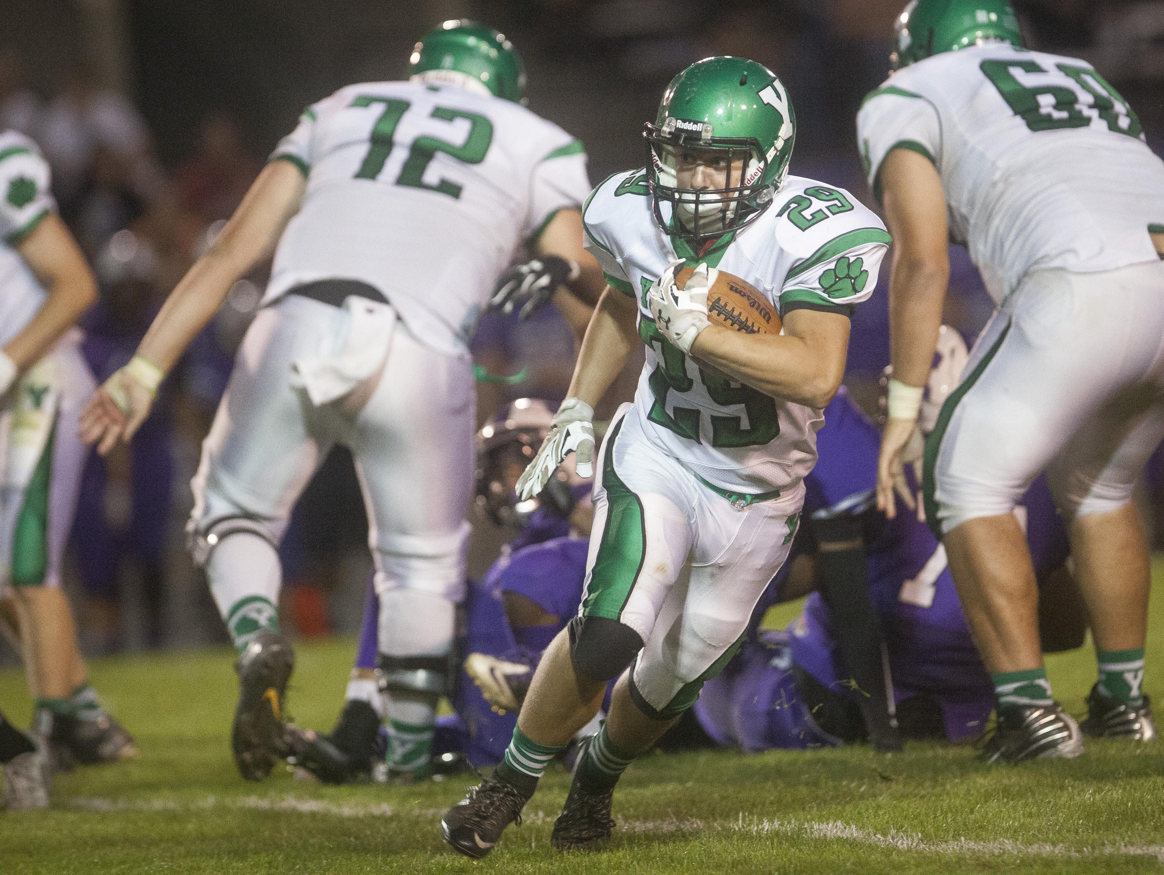 Yorktown's Wayne Morrow takes off downfield with the ball for a Yorktown first down Friday evening during the game at Muncie Central.