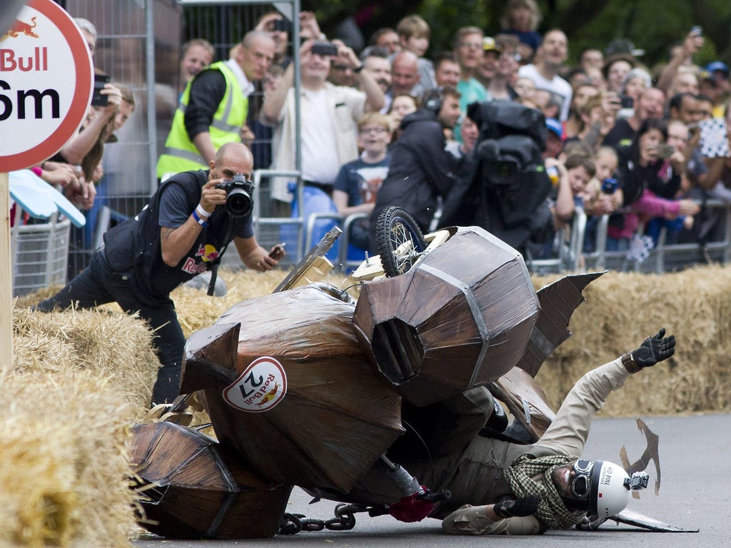 A team crashes into hay bales in the Red Bull Soapbox race in London. The Red Bull Soapbox race is an annual event in which amateur drivers race with their homemade soapbox vehicles down a hill through obstacles.