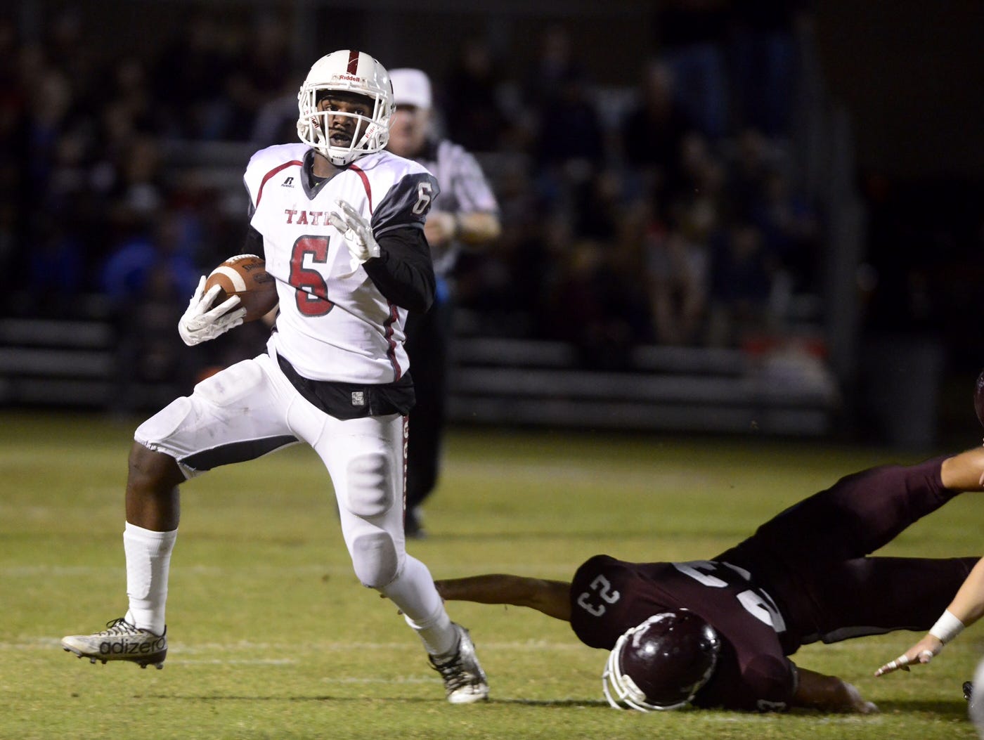 Tate High School's Dee Thompson avoids a tackle from Niceville's Scott Armfield Friday as the Aggies hold on to beat the Eagles 21-20. Tate advances to the Class 6A State Semifinals vs. Seffner Armwood.