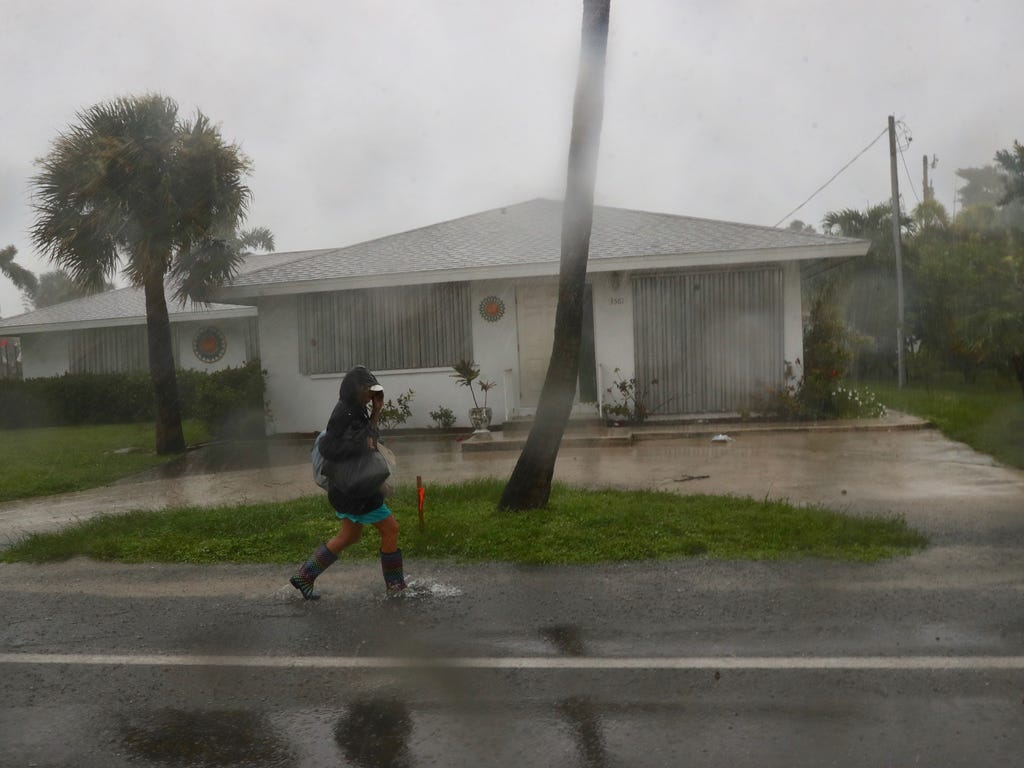 A woman who refused to be identified tries to find shelter on Fort Myers Beach, Fla., as Hurricane Irma approaches on Sept. 10, 2017. She was heading to a nearby church hoping someone was there to take her in.