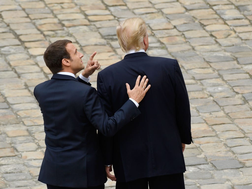 French President Emmanuel Macron, left, gestures as he welcomes President Trump, during a welcome ceremony at Les Invalides in Paris on July 13, 2017.