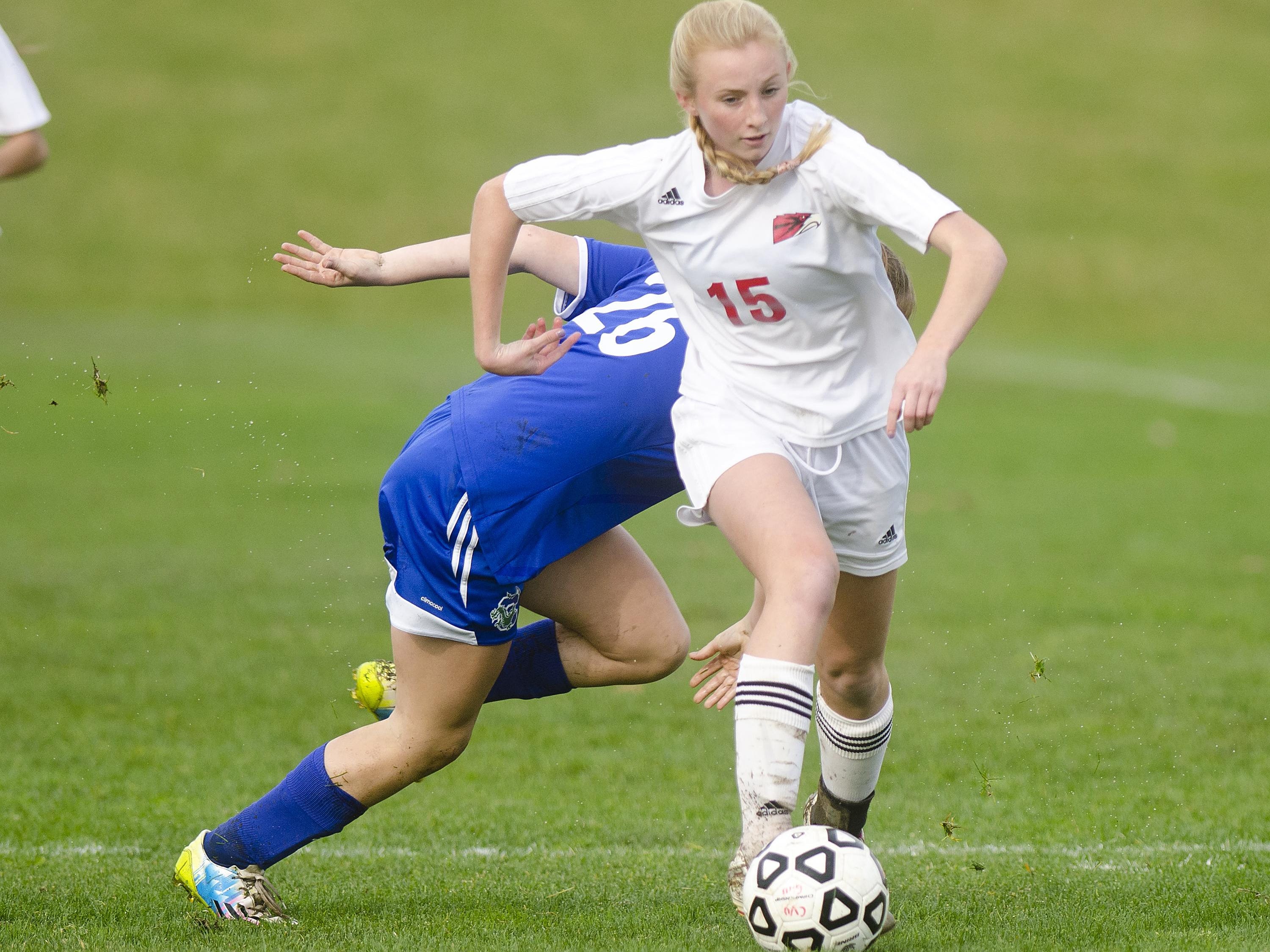 Champlain Valley's Sierra Morton (15) dribbles past a Colchester defender during the first half of Tuesday's girls soccer playoff game in Hinesburg.