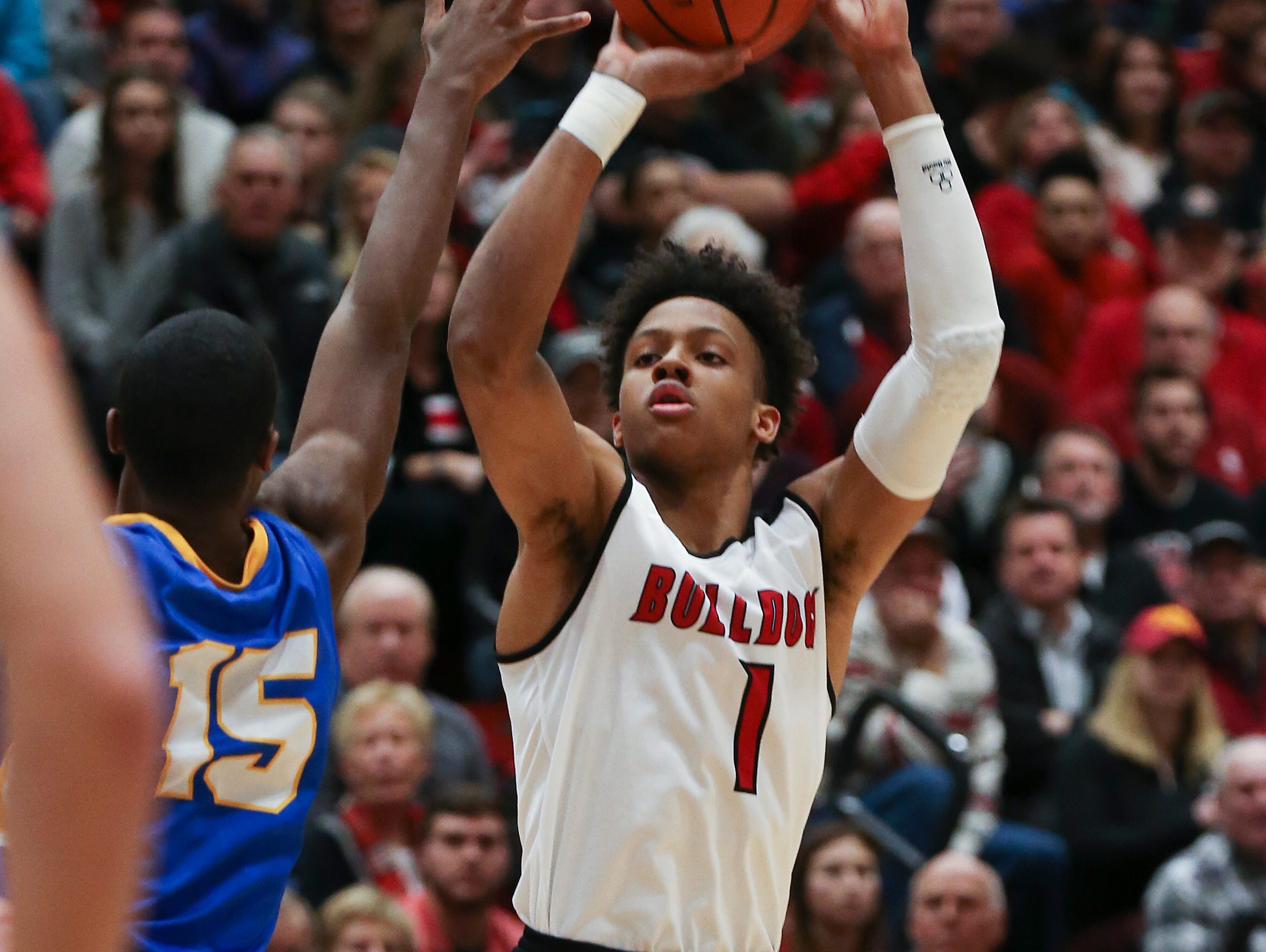 New Albany’s Romeo Langford (1) shoots against Carmel’s Jalen Whack (15) during their game at New Albany High School. New Albany edged Carmel 55-52. Dec. 20, 2016