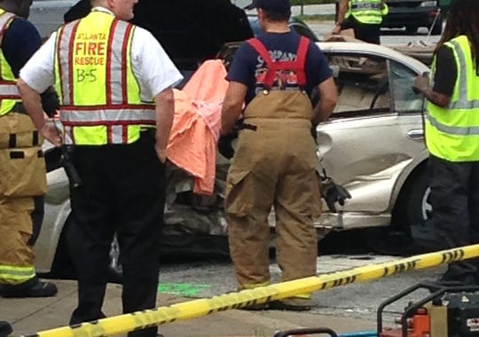 Emergency responders examine the scene of an accident