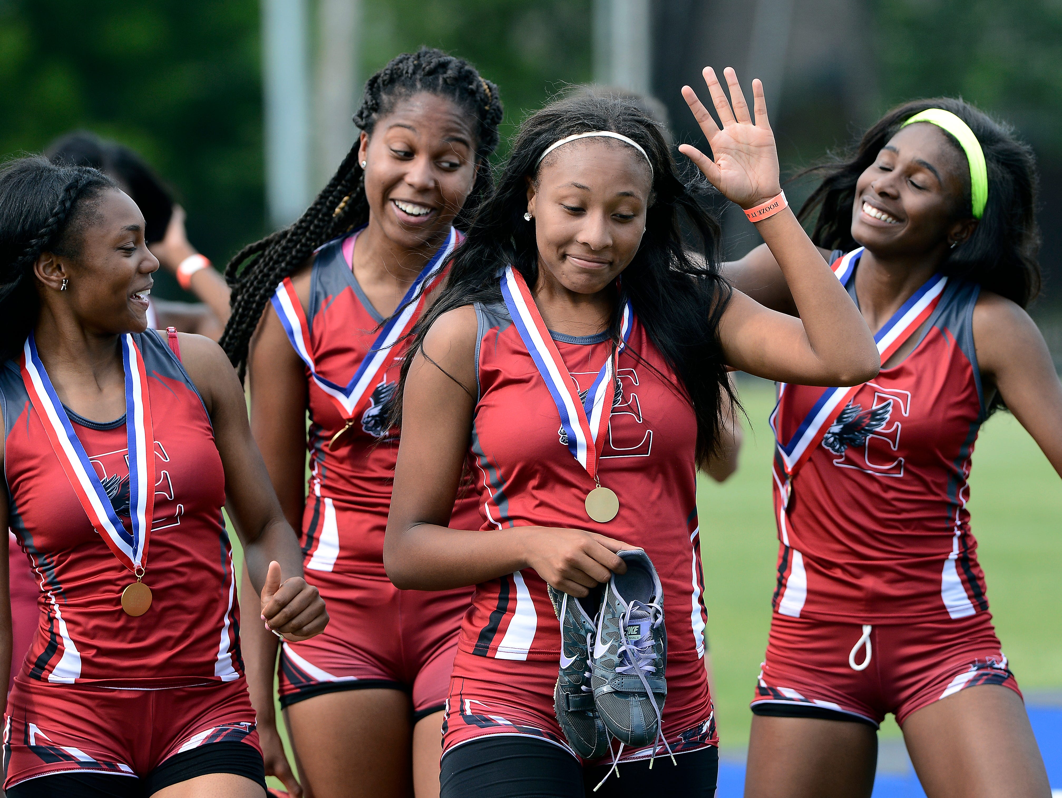 East Nashvilles' Alexis Patterson, left, Alexis Butler, Kenndi Johnson and Aaliyah Cummings celebrate after receiving their Class A-AA state championship medals for the 4x200 meter relay during the Tennessee girls state track championships at Middle Tennessee State University.