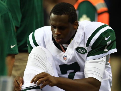 New York Jets quarterback Geno Smith (7) his is ankle examined after limping off the field in the third quarter of a preseason game against the Detroit Lions at Ford Field.