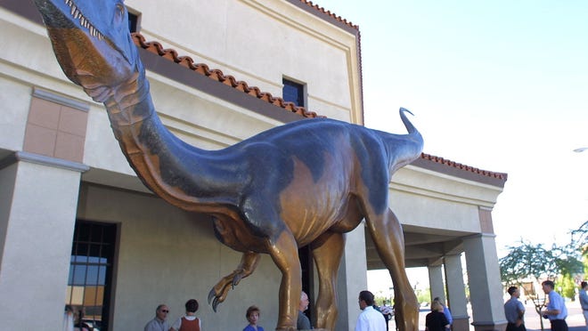 46390 DINO27 A 20-foot long, life-size bronze Dilophosaurus, created for the Mesa Southwest Museum by artist Michael Trcic, of Sedona, is a native species to Arizona. Cori Takemoto Williams/The Arizona Republic August 26, 2002.
