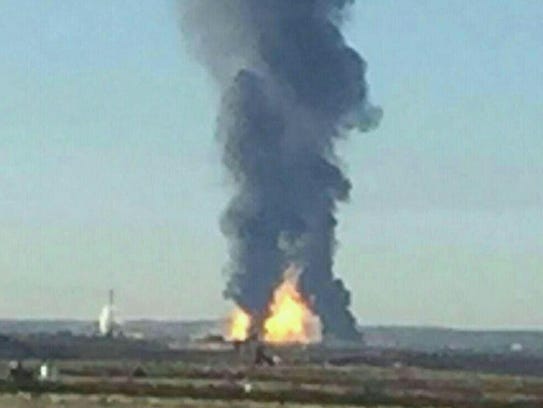 A large fire and smoke is seen from the distance of