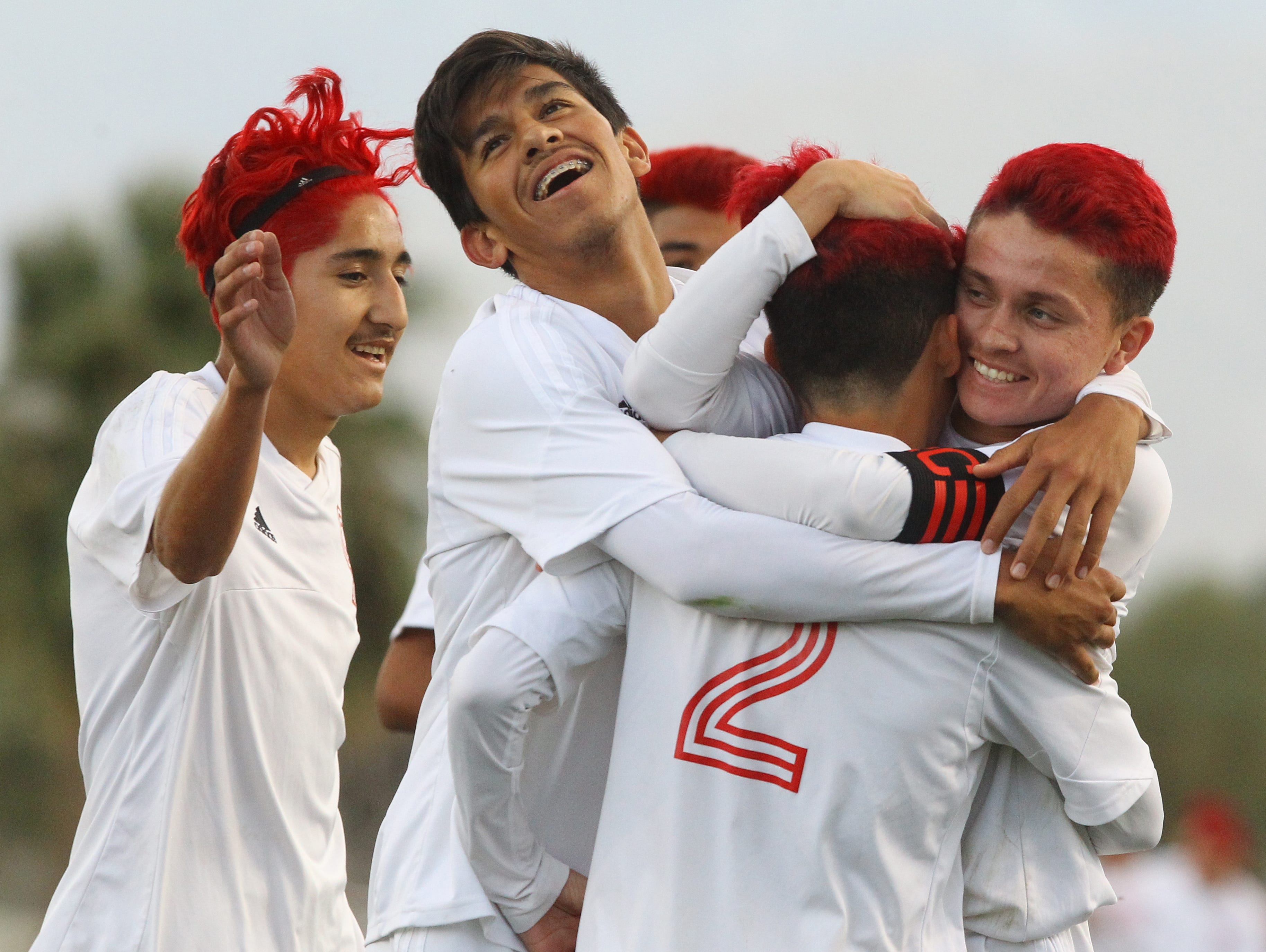 Desert Mirage High School's Erick Serrano is hugged by team mates after scoring the third goal of his team against Littlerock in Thermal on February February 16, 2017. Desert Mirage won 3-1.