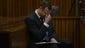 Pistorius grimaces as he sits in the dock listening to cross questioning about the events surrounding the shooting death of his girlfriend Reeva Steenkamp.