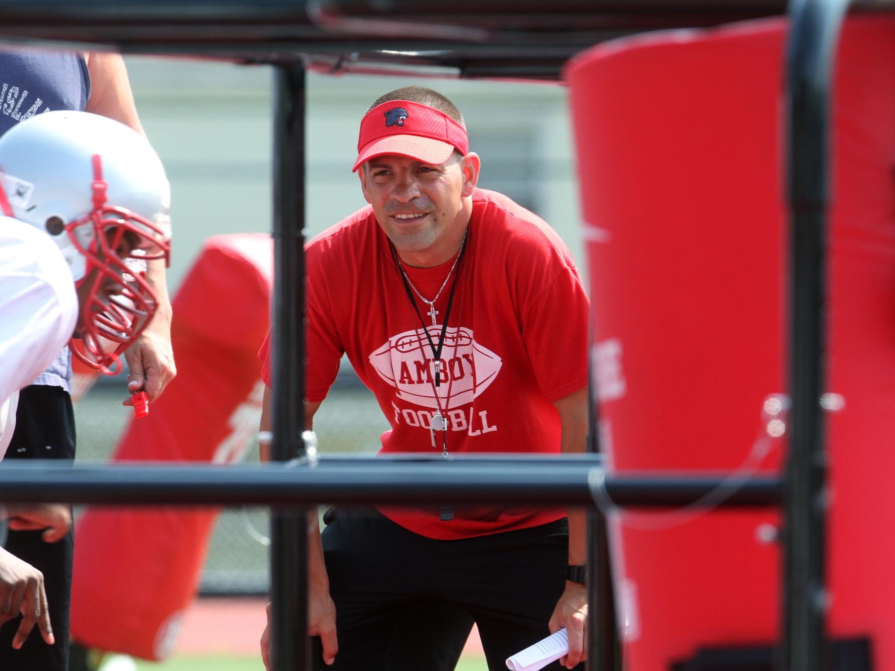 Perth Amboy first year football coach Brad Bishop works with his players during preseason practice, Wednesday, August 20, 2014, in Perth Amboy, NJ. Photo by Jason Towlen