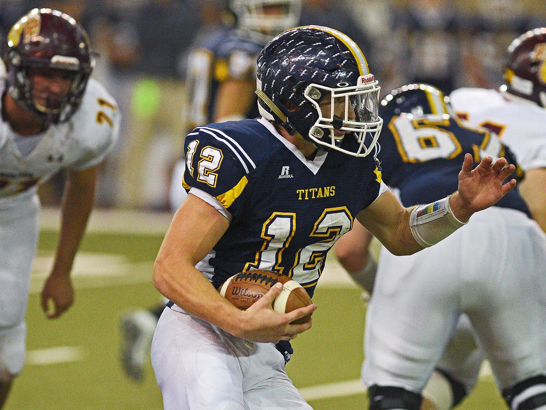 Tea Area's Payton Conrad (12) carries the ball during the 2016 South Dakota State Class 11A Football Championship game against Madison Saturday, Nov. 12, 2016, at the DakotaDome on the University of South Dakota campus in Vermillion, S.D. Madison beat Tea Area 39-0.