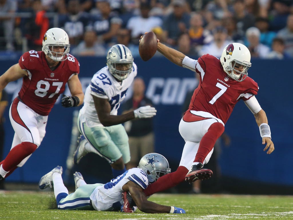 Arizona Cardinals quarterback Blaine Gabbert, right, is sacked by Dallas Cowboys cornerback Anthony Brown, bottom,  during the first quarter at Tom Benson Hall of Fame Stadium.