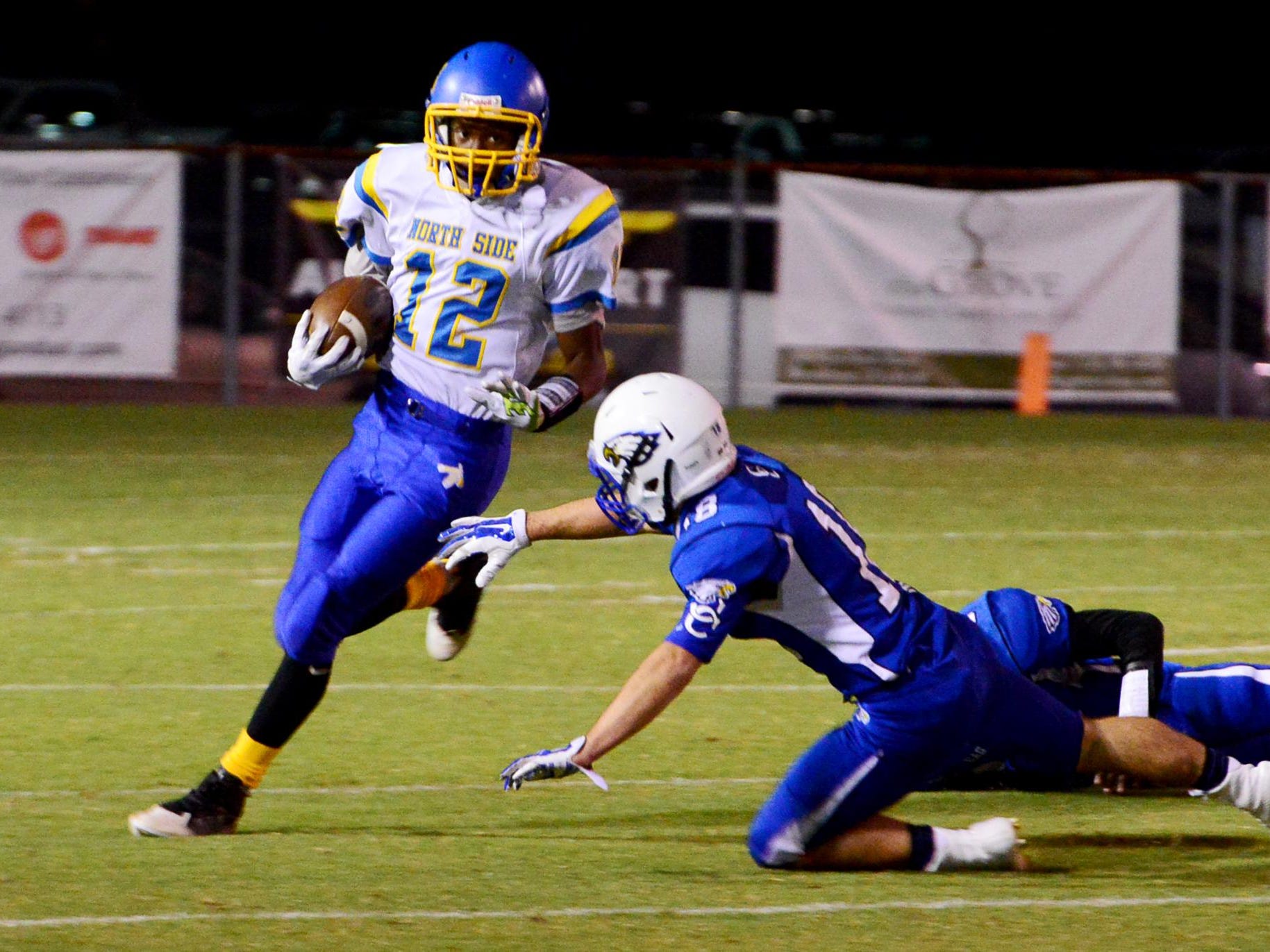 North Side's Dexter Pirtle attempts to avoid a tackle from a Chester County defender during their game Friday evening.
