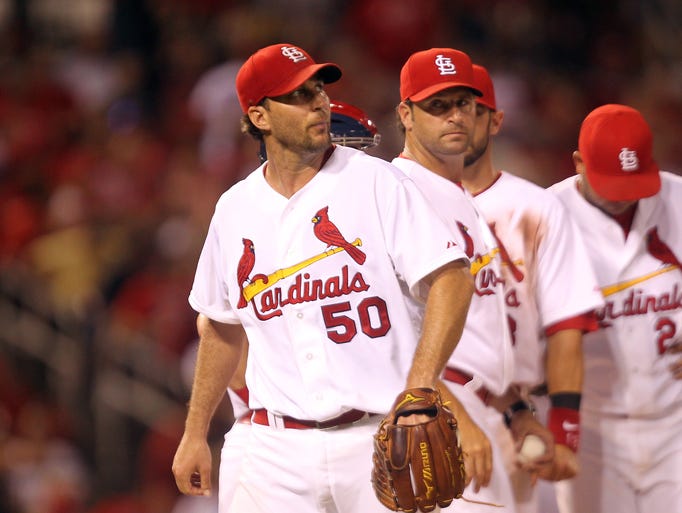 St. Louis Cardinals manager Mike Matheny looks at starting pitcher Adam Wainwright as he leaves the game against the Tampa Bay Rays in the fifth inning at Busch Stadium in St. Louis on July 22, 2014.