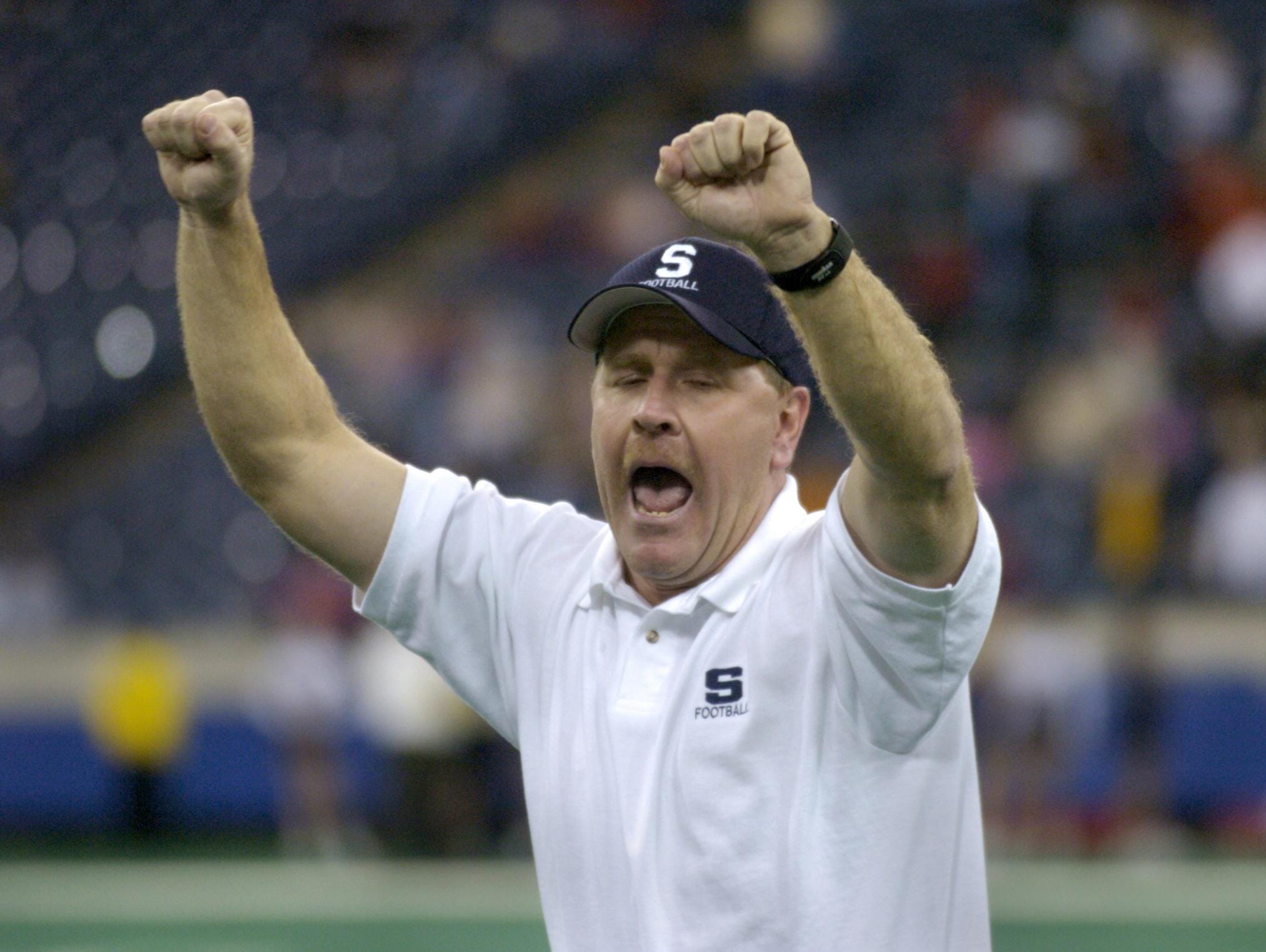 Brian Moore, then with Seeger, celebrates his team's 20-7 victory over Cardinal Ritter High School in the IHSAA Class 1A football finals in November 2004.Indianapolis Star 11/26/04--w/story--WHS1A27--Seeger High School's head football coach Brian Moore celebrates his team's 20-7 victory over Cardinal Ritter High School in the IHSAA Class 1A football finals at the RCA Dome in Indianapolis Friday Nov. 26. Staff Photo by Joe Vitti File #106037