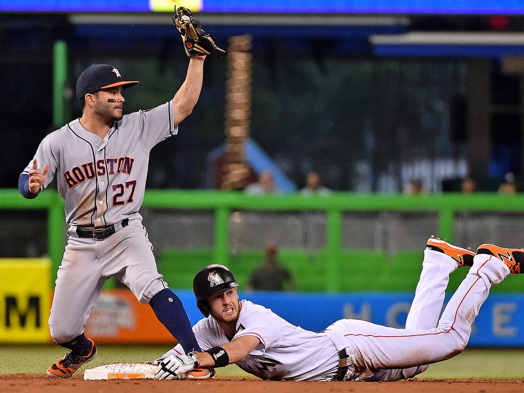 Miami Marlins shortstop JT Riddle reacts after being tagged out by Houston Astros second baseman Jose Altuve at Marlins Park in Miami.