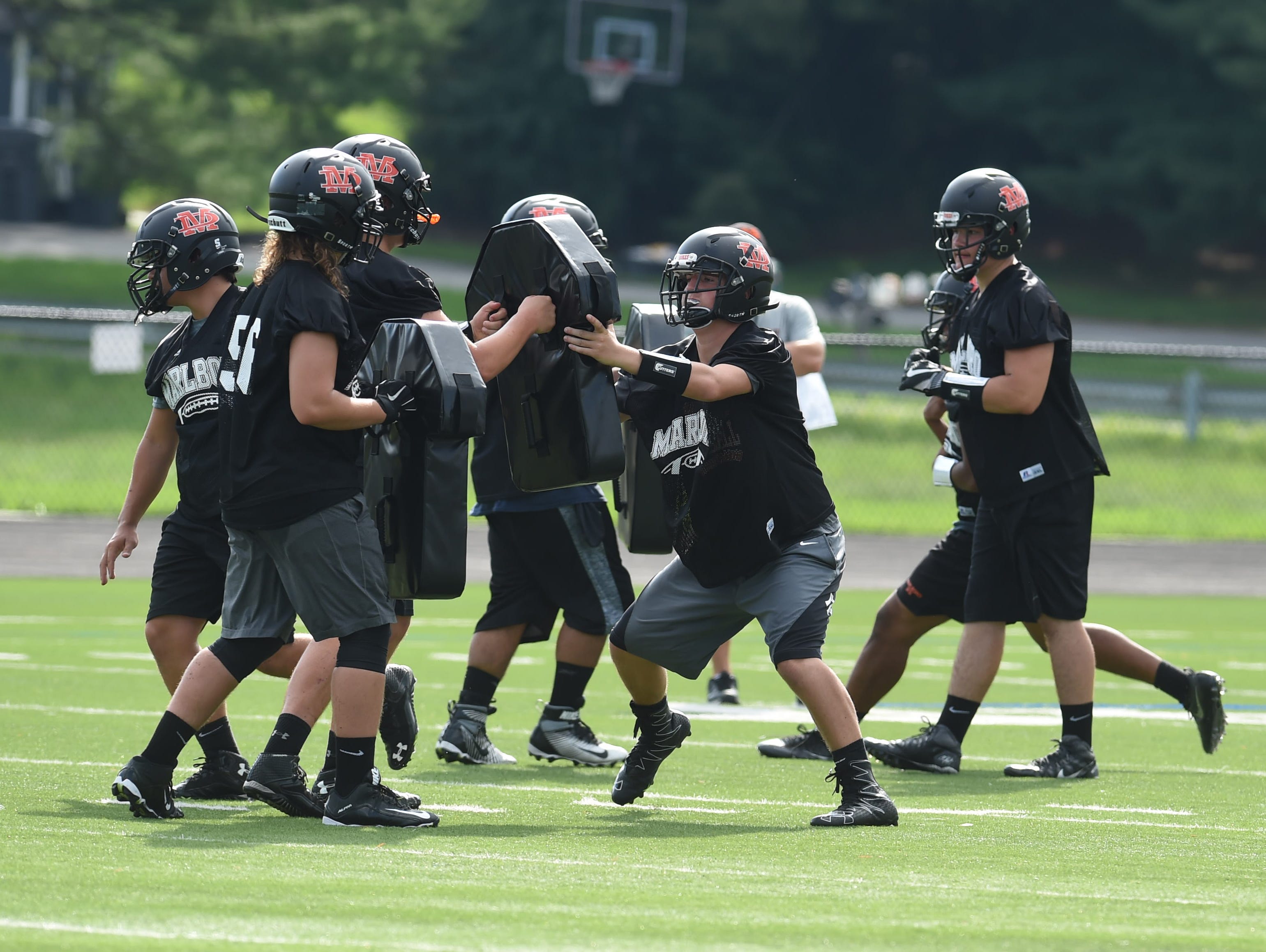 Sophomore Nick Esposito, left, prepares for a block during football preseason practice at Marlboro High School.