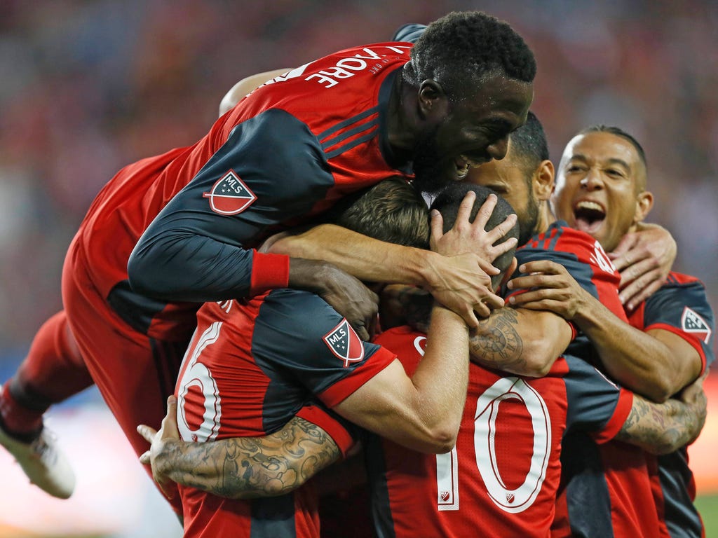 Toronto FC forward Sebastian Giovinco  celebrates with teammates after scoring a goal during the first half against the Philadelphia Union at BMO Field in Toronto. Toronto FC won the game, 3-0.