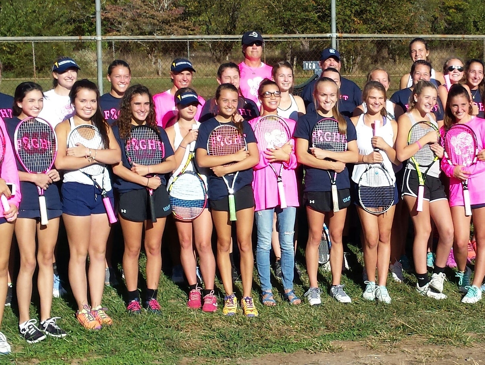 Enka and Roberson tennis players are pictured together following their Oct. 6 match for breast cancer awareness ini Skyland. The Rams won, 9-0.