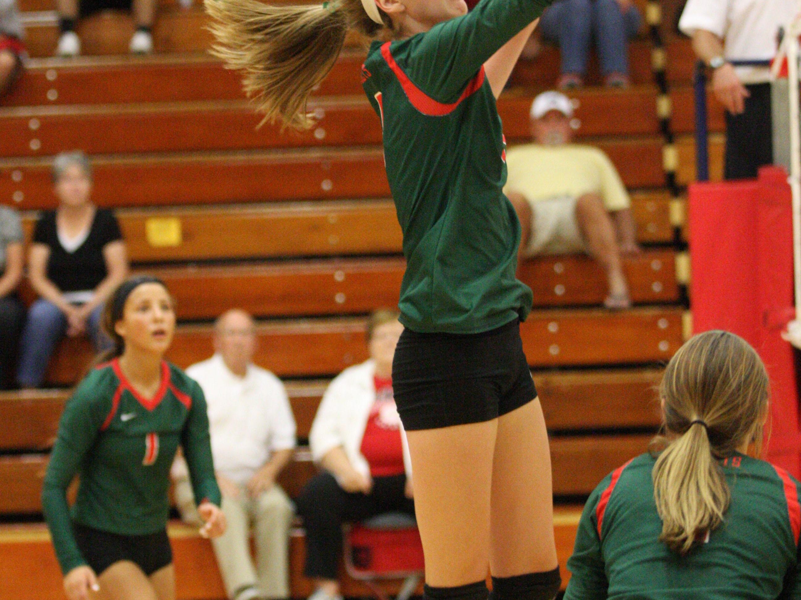 Oak Harbor's Peyton Bloomer tips the ball over the Oak Harbor defense. Photo by Doug Hise.