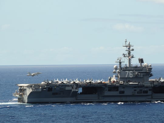 An F/A-18 Super Hornet lands aboard the aircraft carrier