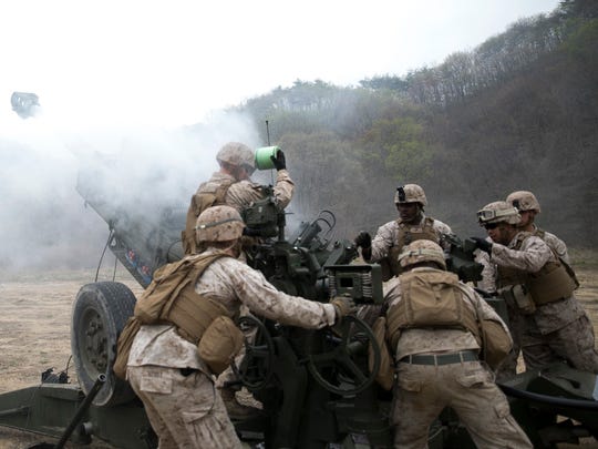 Artillery Marines fire off rounds from M777A2 lightweight