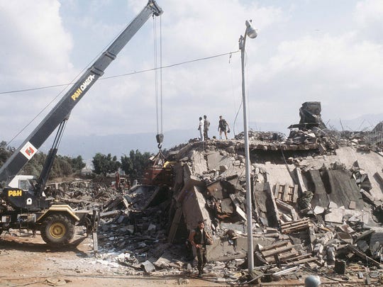 Emergency crews work in the rubble of the U.S. Marine