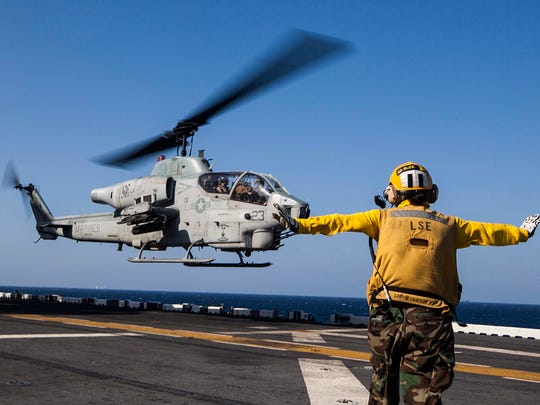 An AH-1W Super Cobra helicopter with Marine Medium