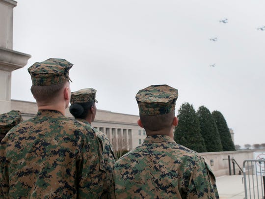 Marines watch the overflight of a division of MV-22B