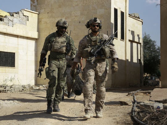 American commandos walk in the Syrian village of Fatisah,