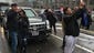 Bystanders take photos outside President Obama's Cadillac
