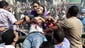 Supporters of ousted Egyptian president Mohammed Morsi move a wounded man during clashes with security forces at Ramses Square.