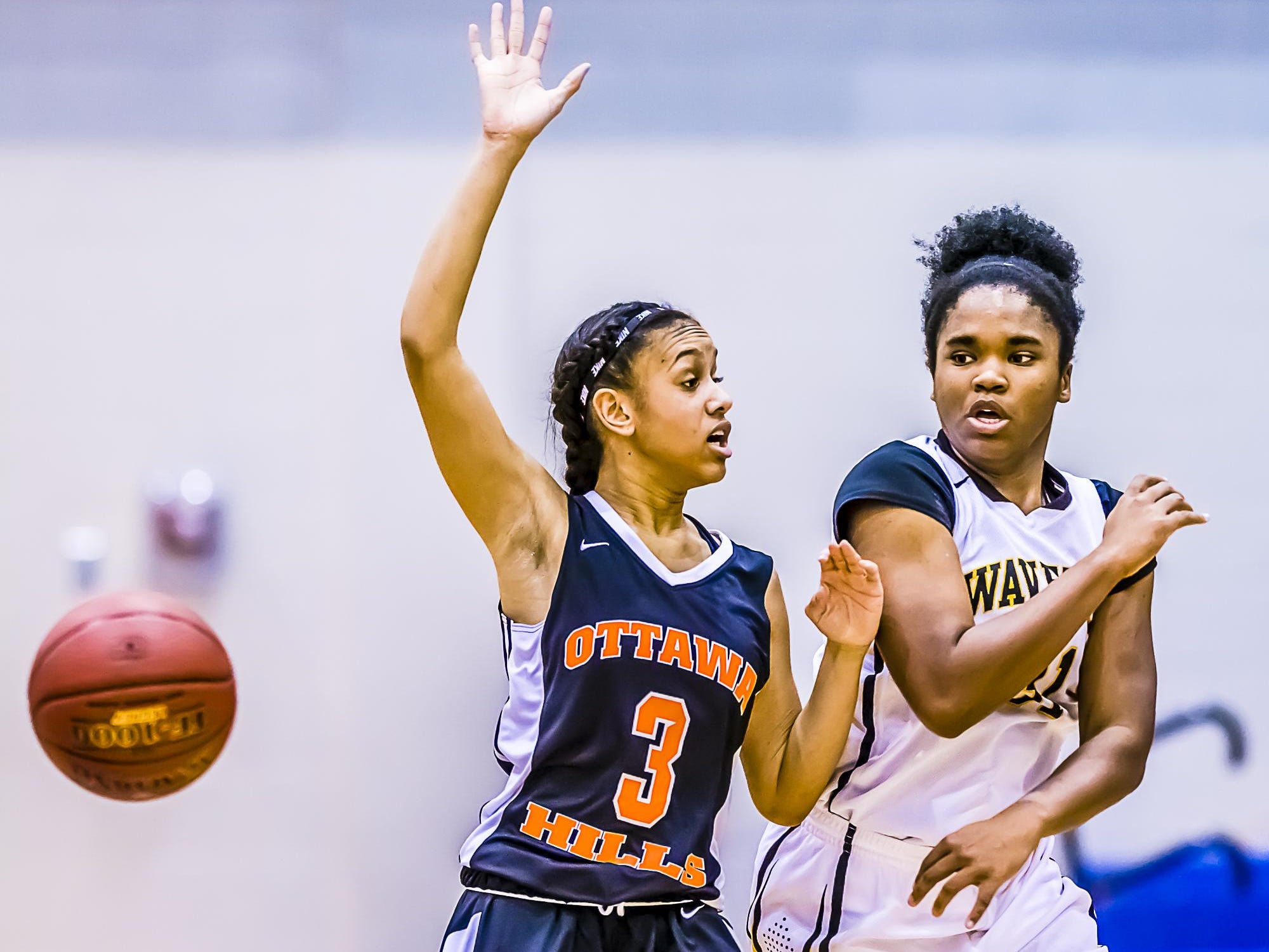 Maya Bennett ,right, of Waverly passes while being defended by Brooklyn Bowman ,3, of Ottawa Hills during their Holiday Hoops Invitational game Tuesday December 29, 2015 at Lansing Community College. KEVIN W. FOWLER PHOTO