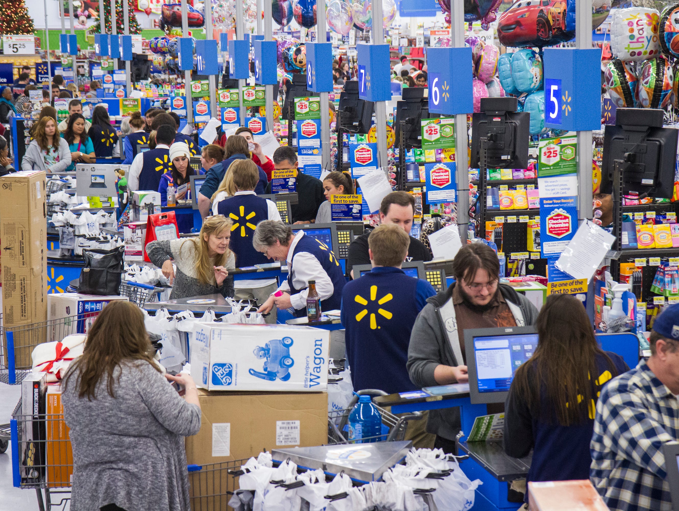 Customers wrap up their holiday shopping during Walmart's Black Friday event Nov. 27, 2014, in Bentonville, Ark.