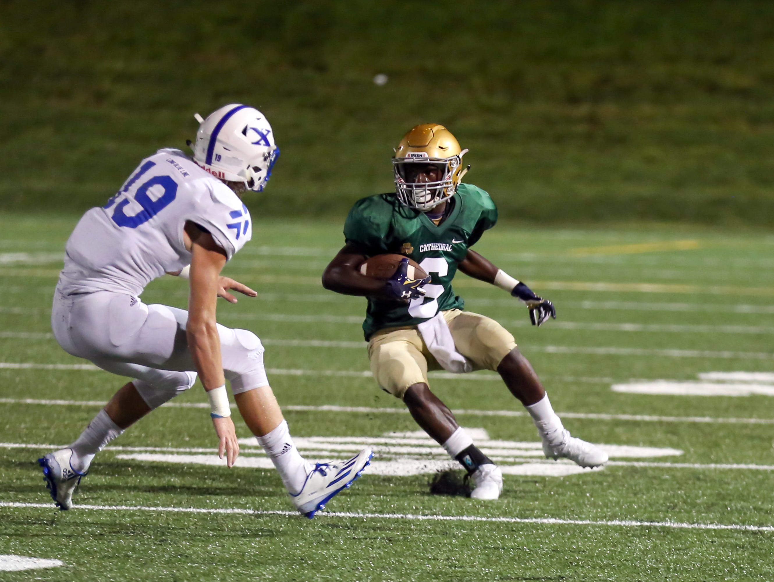 Cathedral's Daijon Collins looks for running room against St. Xavier at the Butler Bowl on Friday night.