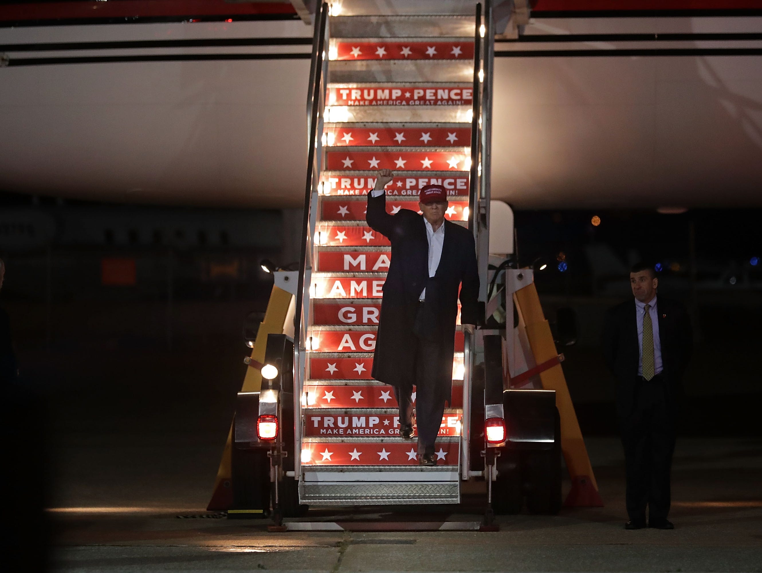 Donald Trump steps off of his airplane after arriving for a campaign rally at Pittsburgh International Airport November 6, 2016.