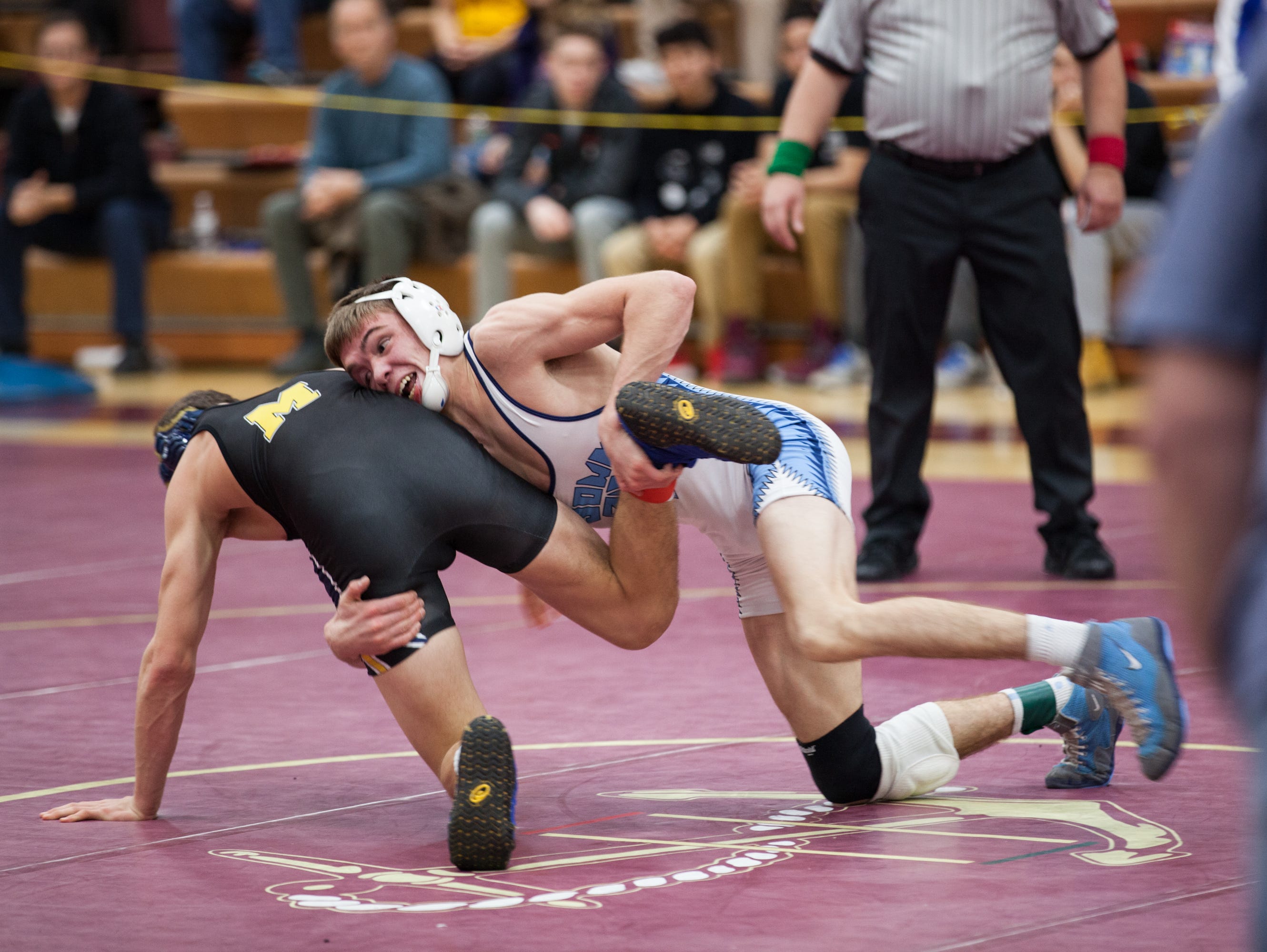 John Jay High School's Randy Earl, right, and Mattituck's Jack Bokina tangle in the 126-pound final at the Mid-Hudson Wrestling tournament at Arlington on Dec. 28.