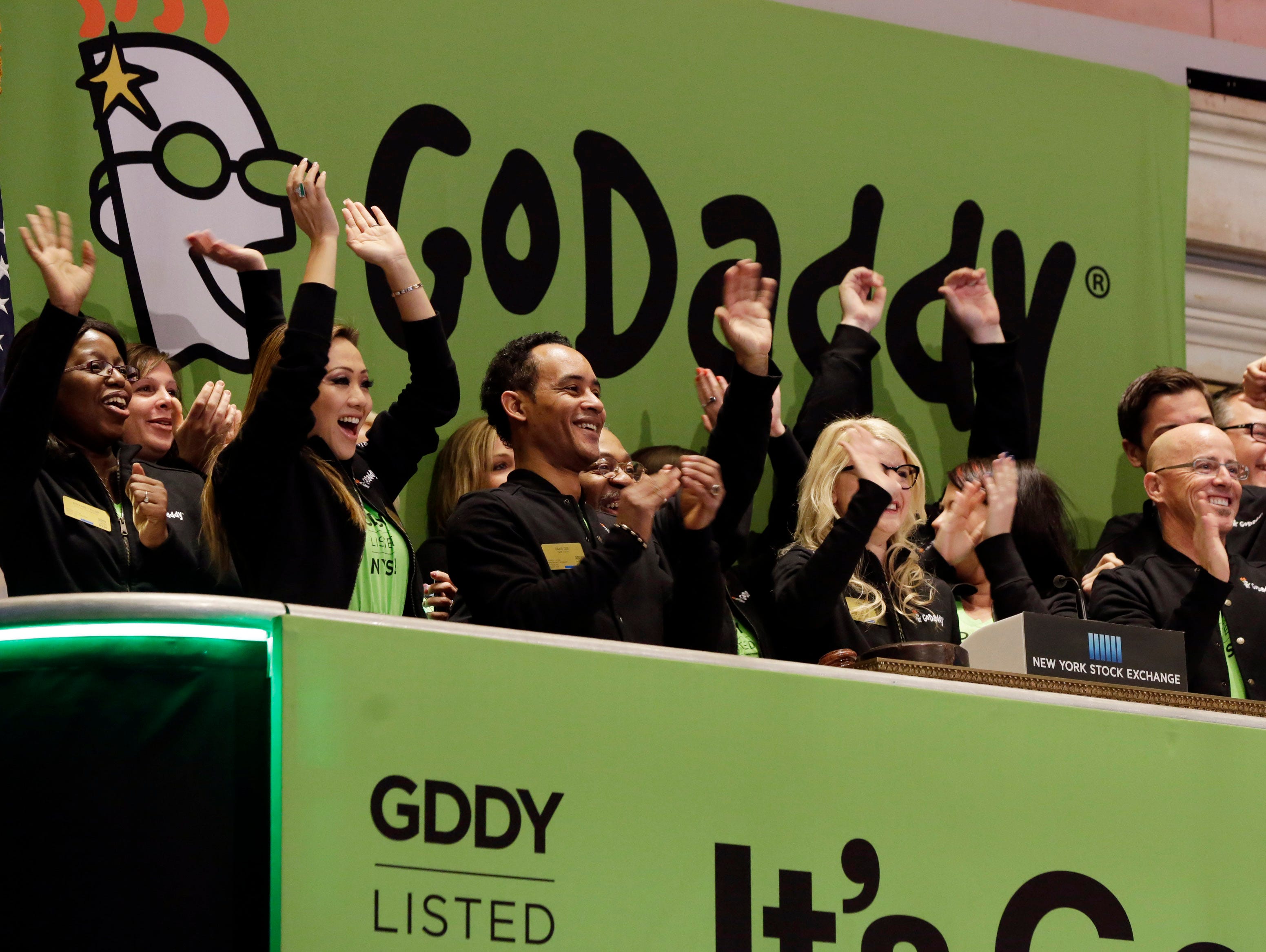GoDaddy CEO Blake Irving, front row right, joins the celebration during New York Stock Exchange opening bell ceremonies for his company's IPO on Wednesday.