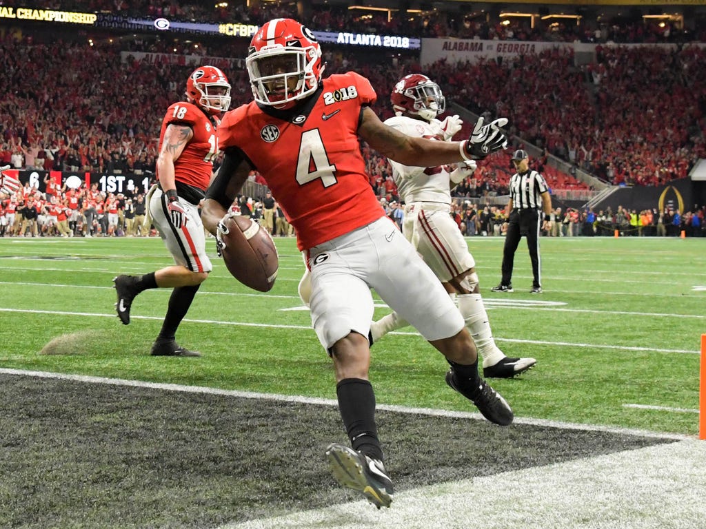 Georgia Bulldogs wide receiver Mecole Hardman runs the ball for a touchdown during the second quarter against the Alabama Crimson Tide in the 2018 CFP national championship college football game at Mercedes-Benz Stadium in Atlanta.