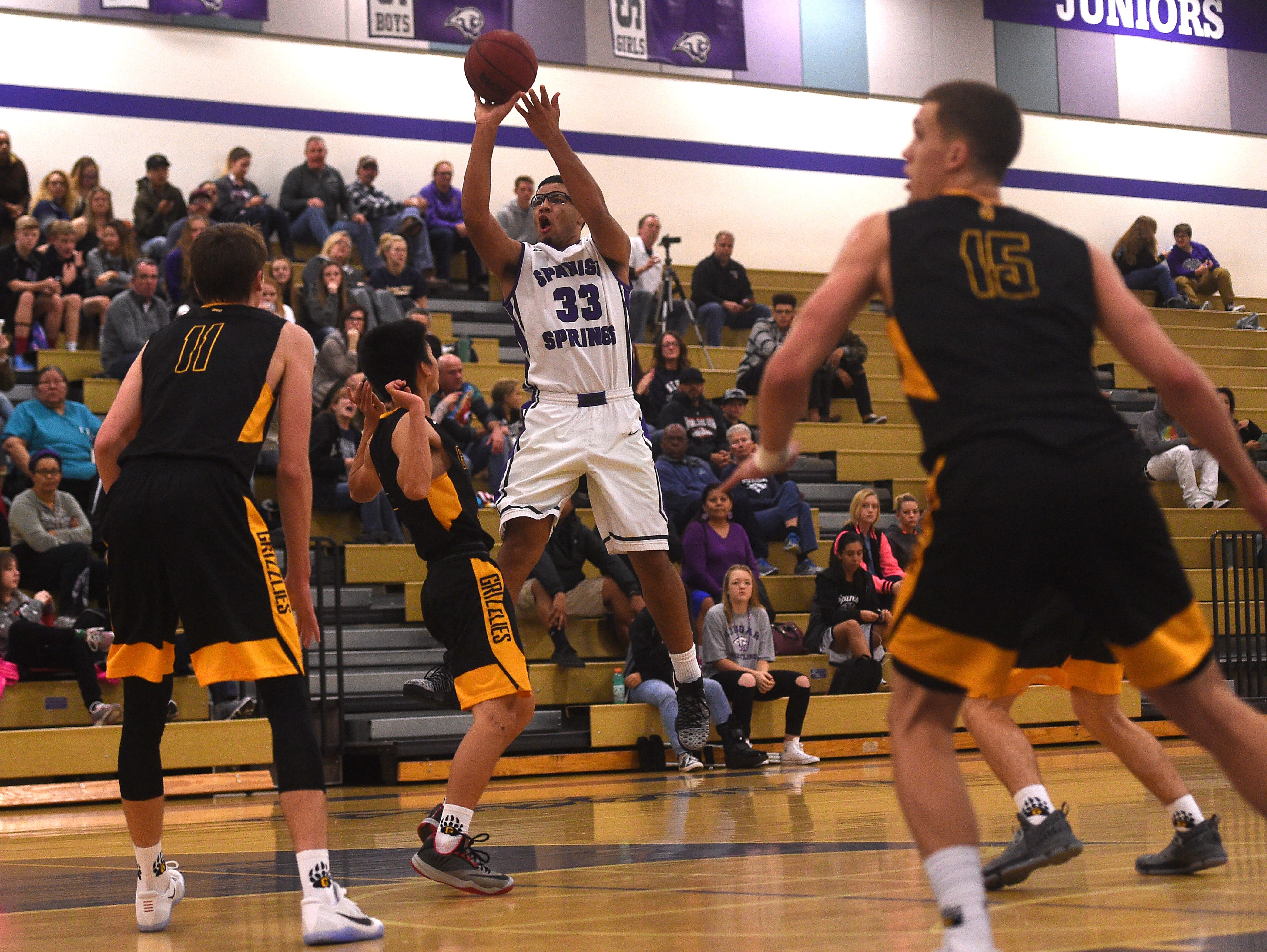 Spanish Springs' Marcus Loadholt (33) shoots while taking on Galena during their basketball game in Spanish Springs on Dec. 16. Dillon Voyles (15) is good friends with Loadholt.