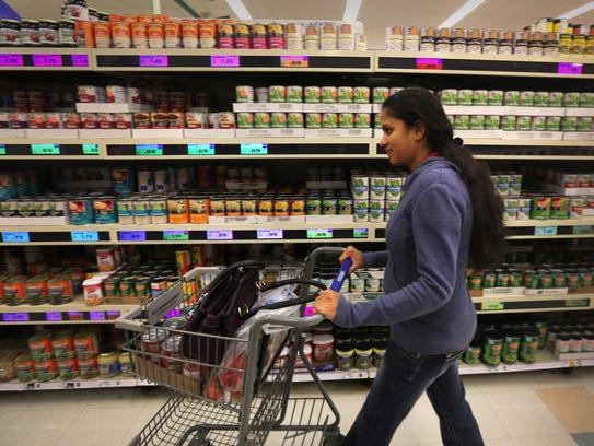 Jasmine Patel of Edgewood walks down the canned food